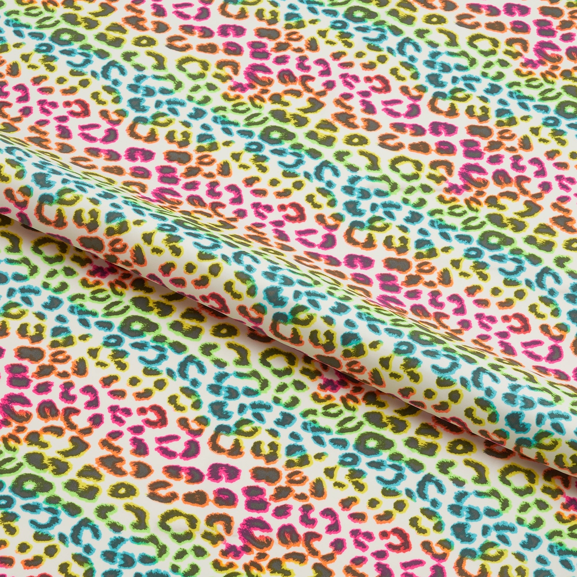 A Sample piece of Rainbow Leo Pattern Printed Spandex Fabric.