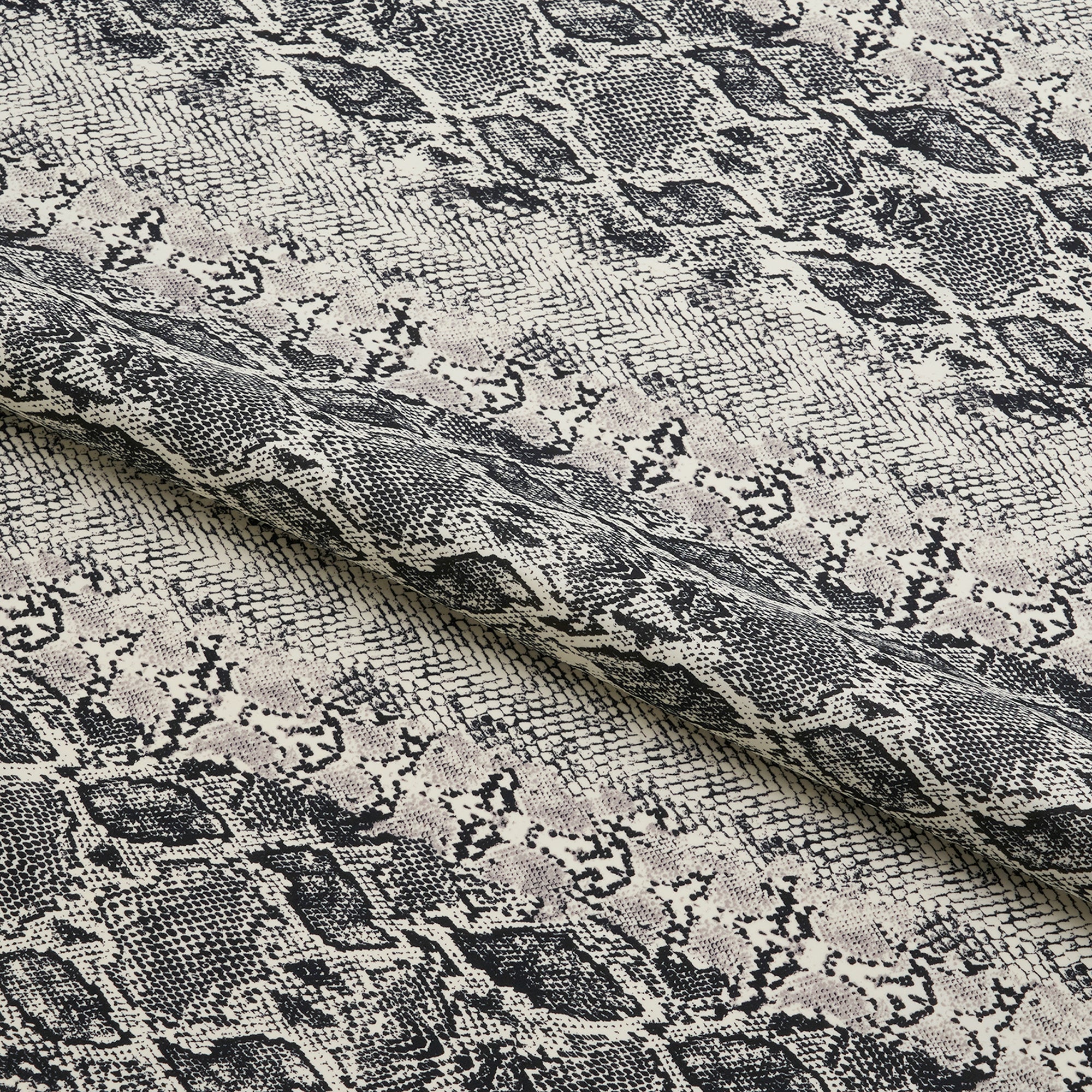 A close-up view of snake skin printed spandex fabric showcasing the texture and pattern.