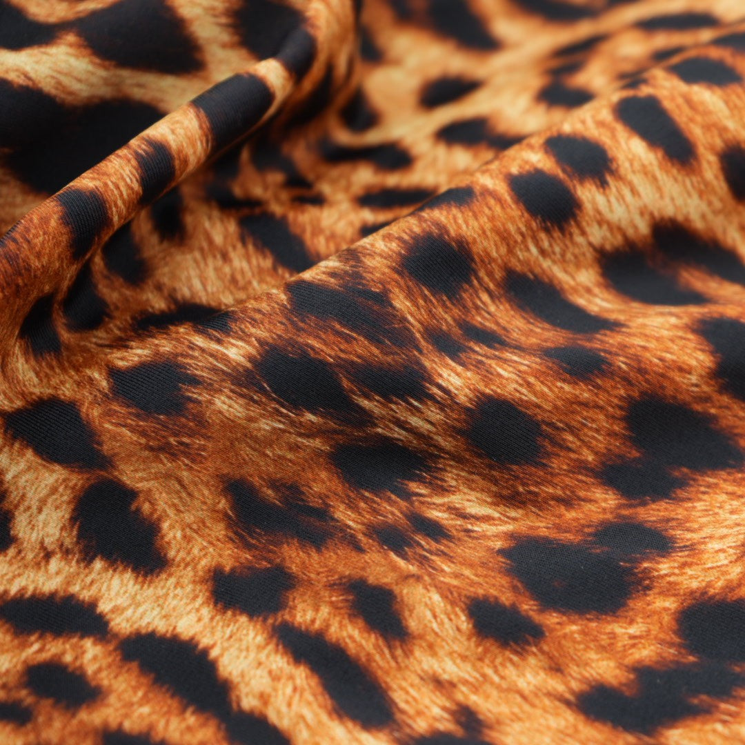 A sample piece of Leopard Spotted Safari Printed Spandex Fabric.