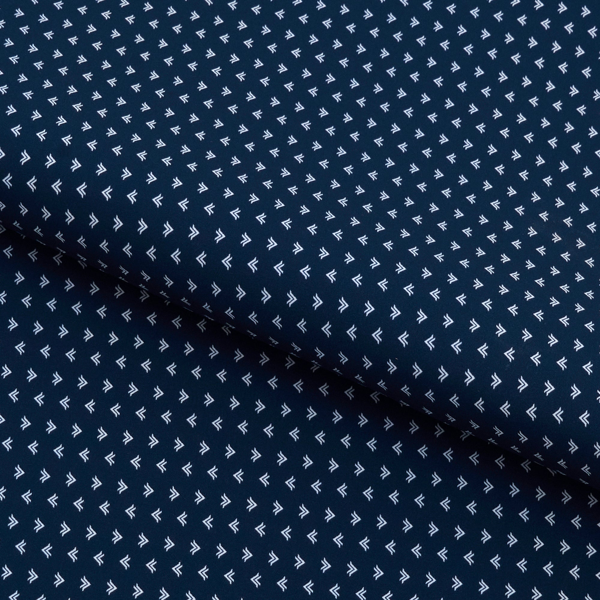 A piece of Left to Right Arrow Printed on Recycled Spandex Fabric in color Navy/White.