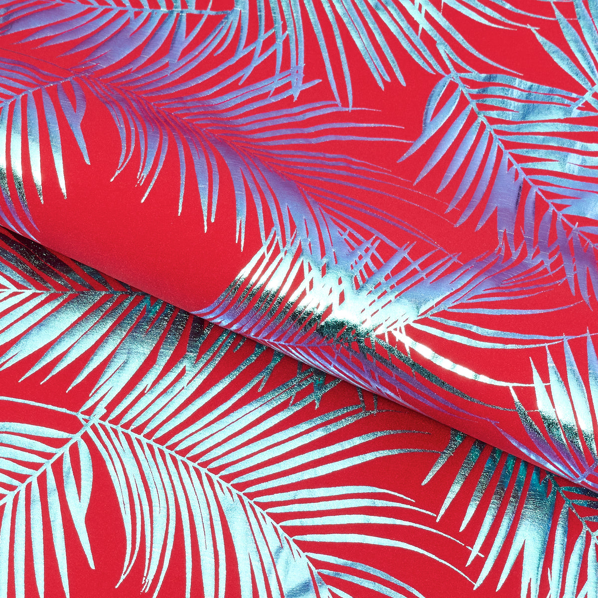 Load video: Hands playing with a sample of Electric Palm Foil Printed Spandex Fabric 4-way Stretch Lurex fabric stretching pulling and tugging at the piece of material with a color in red.
