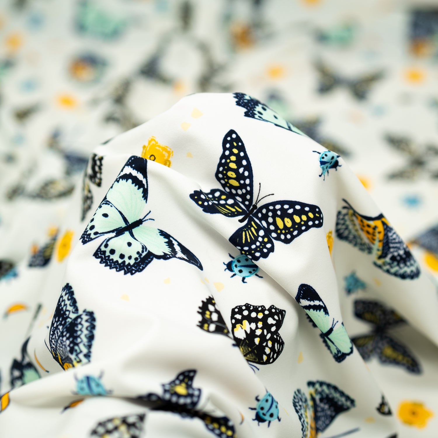 A crumpled piece of Butterflies and Ladybugs Printed Spandex