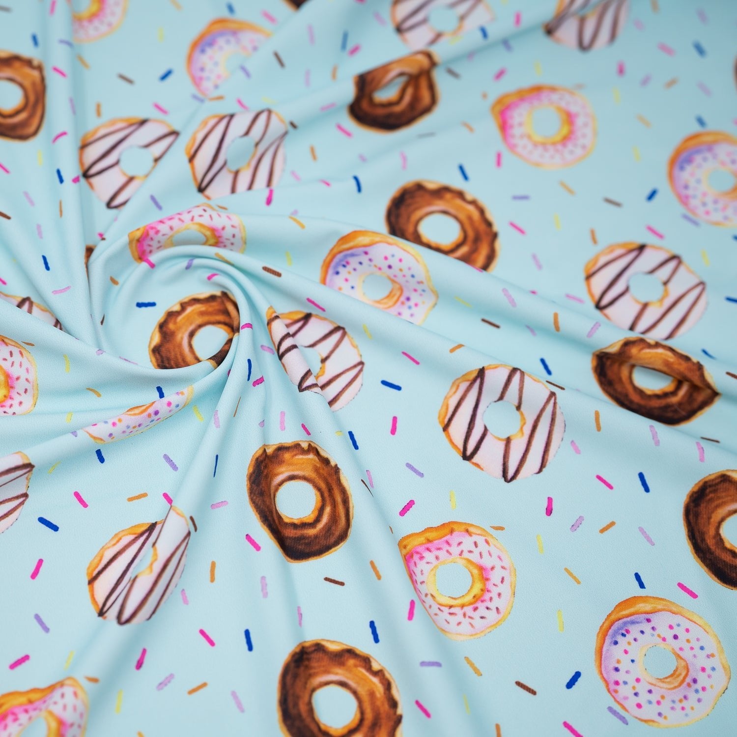 A swirled piece of Dancing Doughnuts Printed Spandex.
