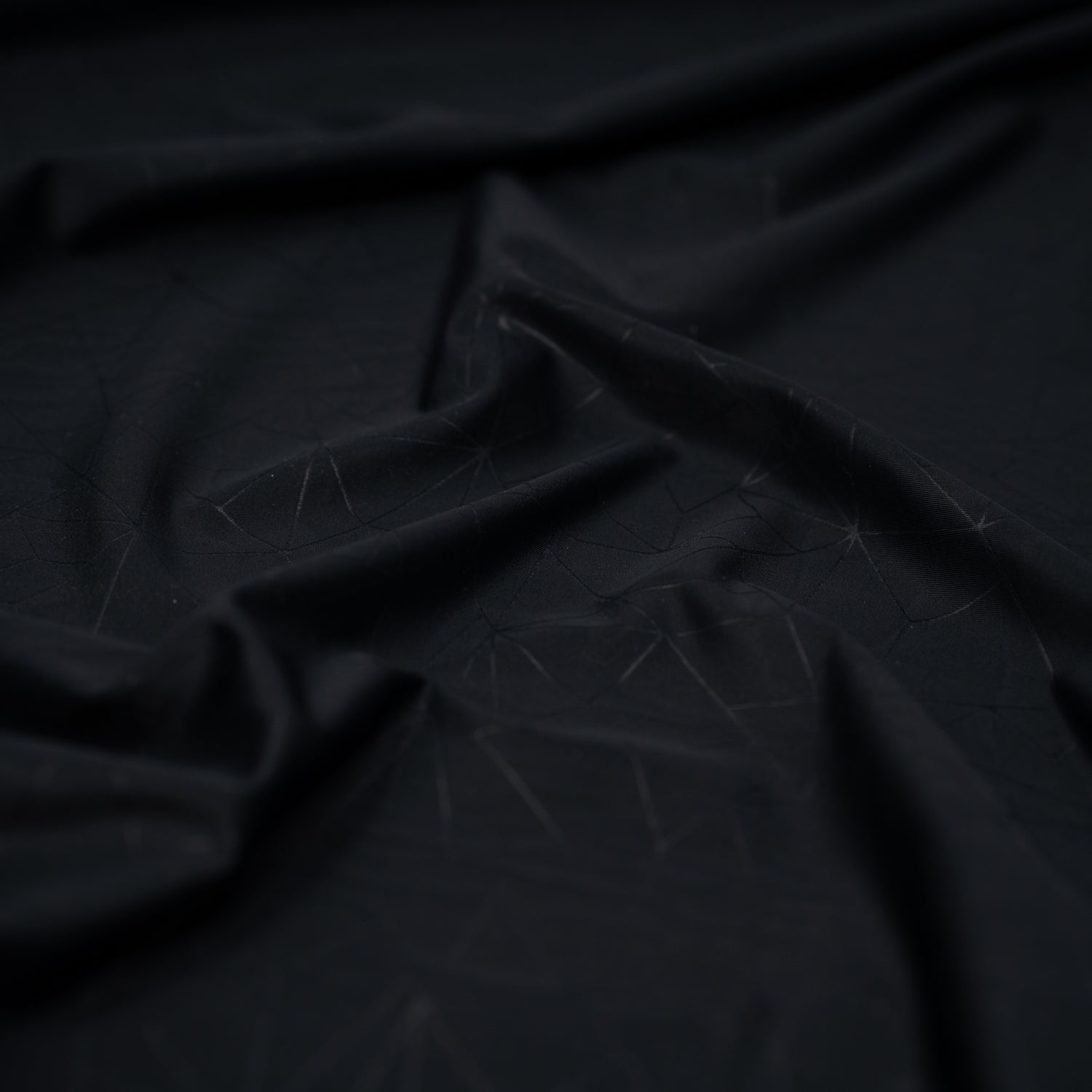 Detailed shot of Geometric Embossed Matte Spandex Tricot in Black.