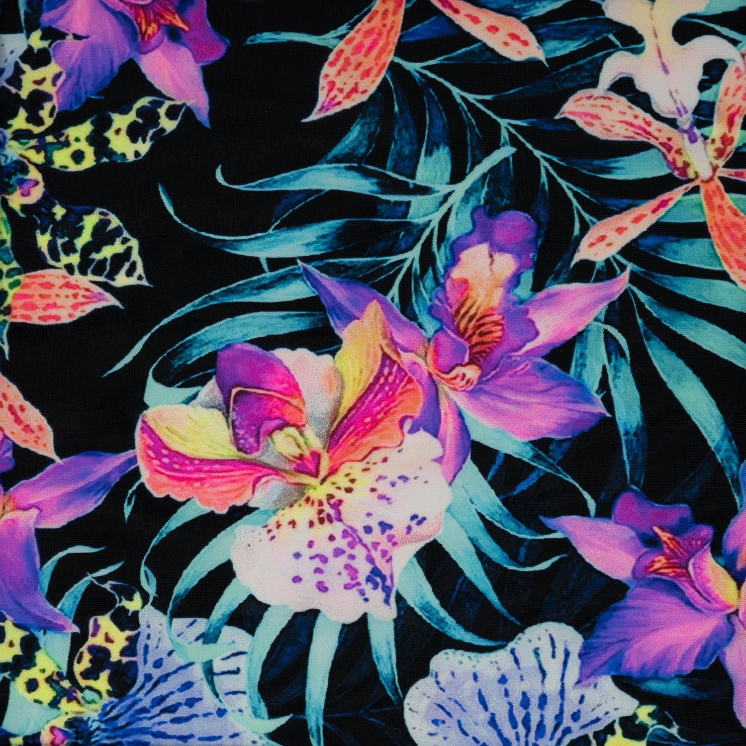 Flat sample of Irises and Palm Fronds Printed Spandex Fabric. The print is of vibrant colored Irises and other exotic flowers over bright light blue fronds on a black background.