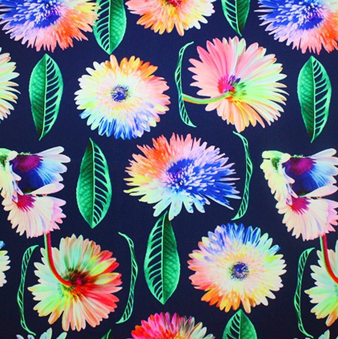 A flat sample of rainbow daisy printed spandex.