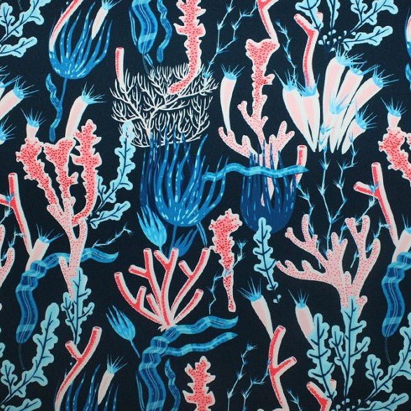A flat sample of coral reef on navy printed spandex.