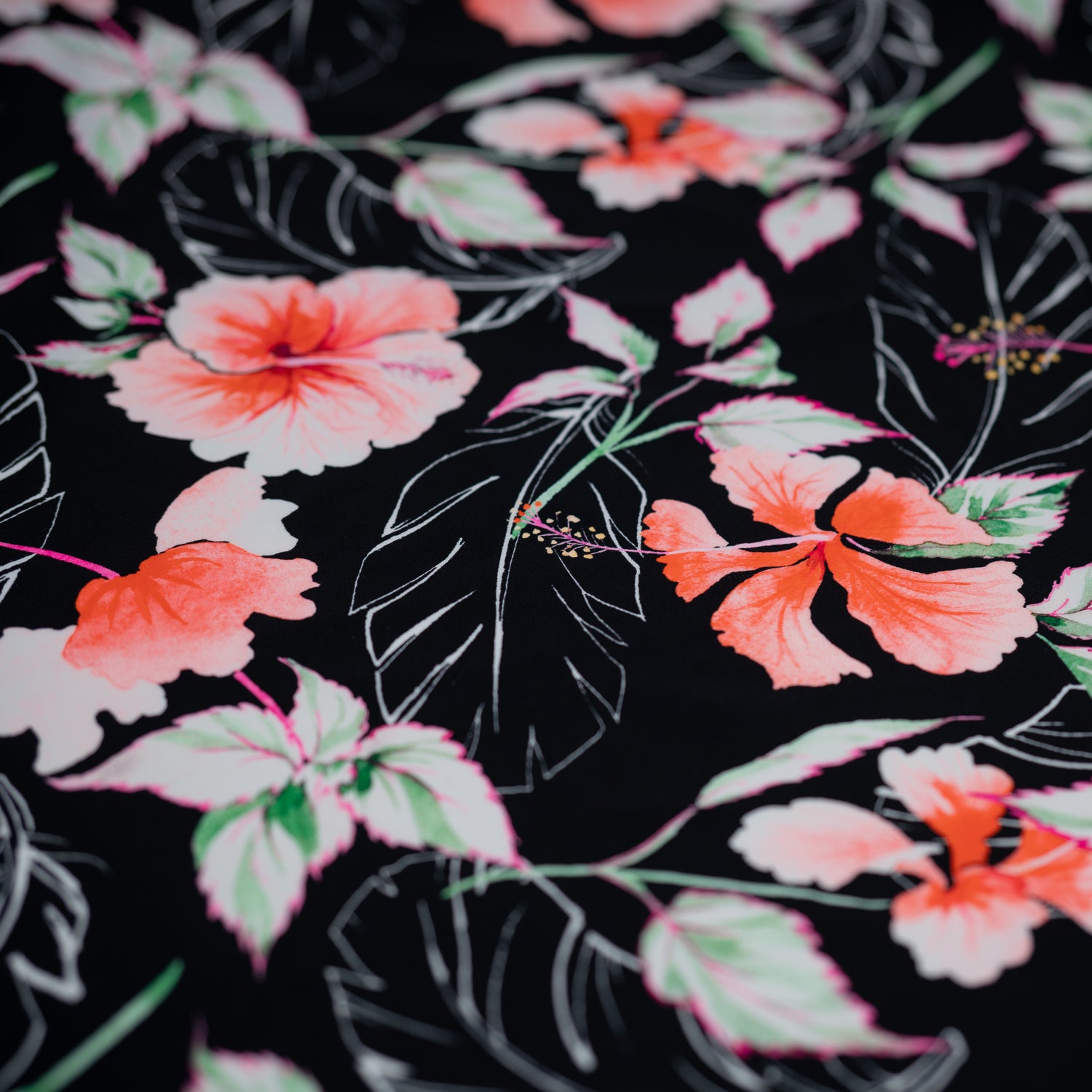 Detailed shot of Hibiscus Flowers on Black Printed Spandex.
