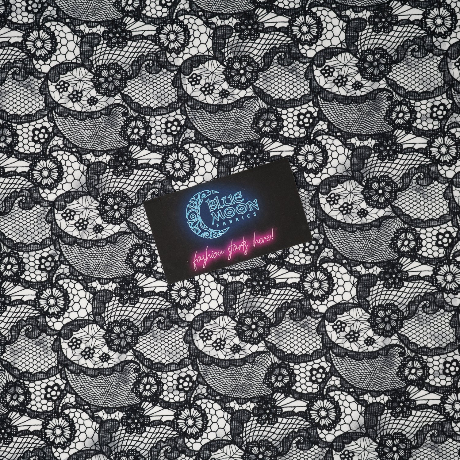 A flat sample of Black Paisley Lace Pattern on White Printed Spandex