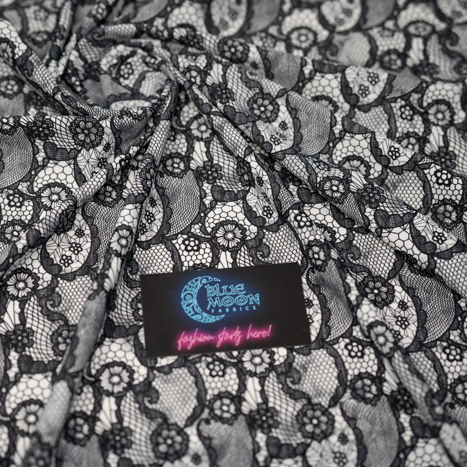 Swirled piece of Black Paisley Lace Pattern on White Printed Spandex