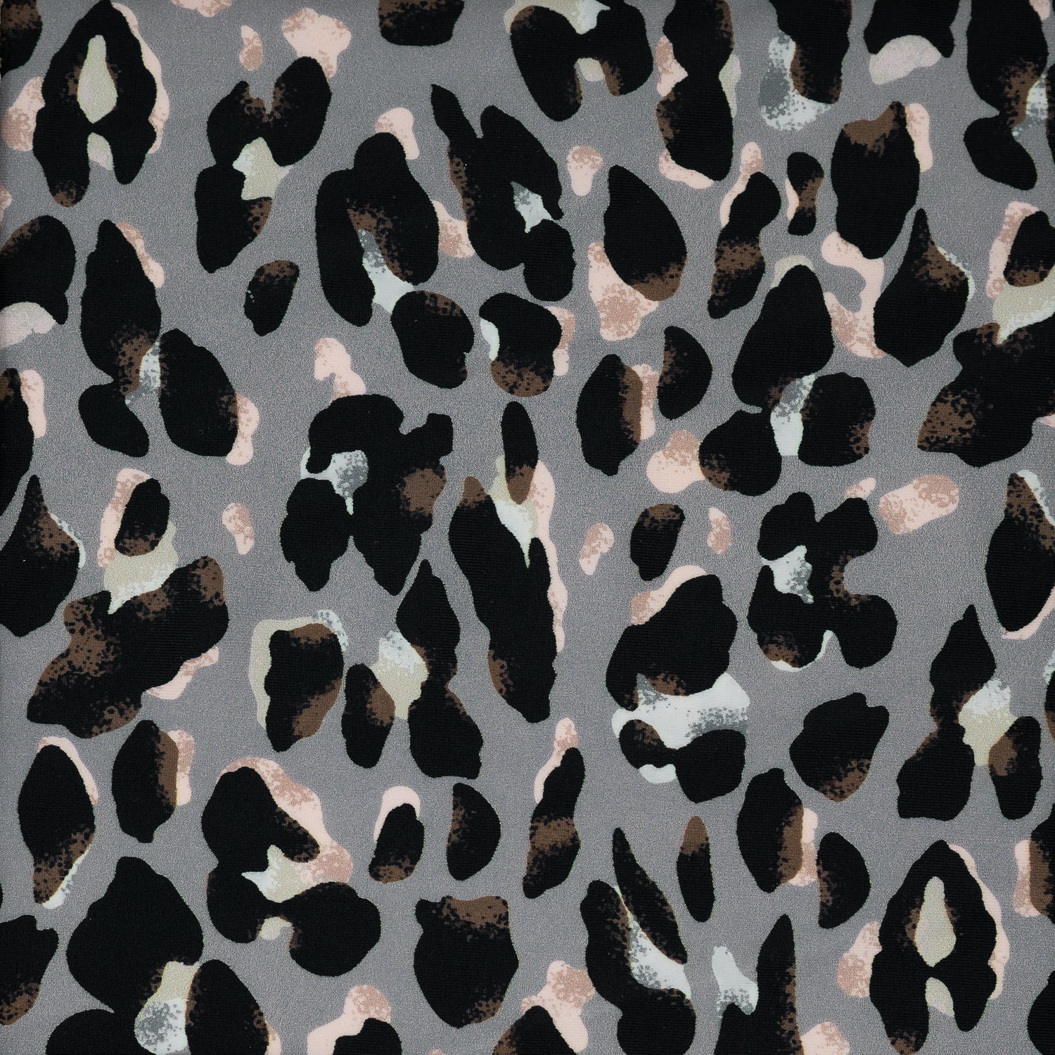 Flat sample shot of Sporty Leopard Printed Spandex Fabric. The print is of black leopard spots with light dust brown accents and light colored shadows on a gray background.