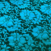 Emma Lace Floral Foil Design Power Mesh Fabric in Black/Turquoise, showing a shimmering floral foil pattern on sheer black mesh.