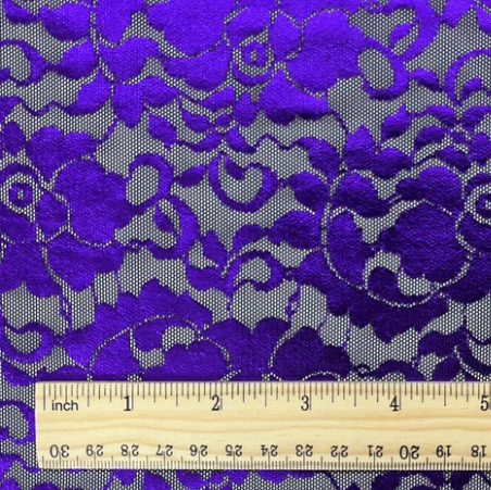 A sample of the Emma Lace Floral Foil Power Mesh next to a ruler to show the scale of the floral design.