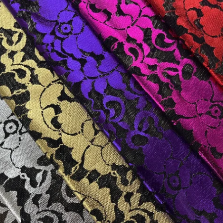 Emma Lace Floral Foil Design Power Mesh Fabric features an intricate floral foil design layered over premium power mesh, available in a vibrant range of colors.