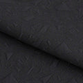 A piece of Geo Puff Jacquard Spandex Fabric in the color black.