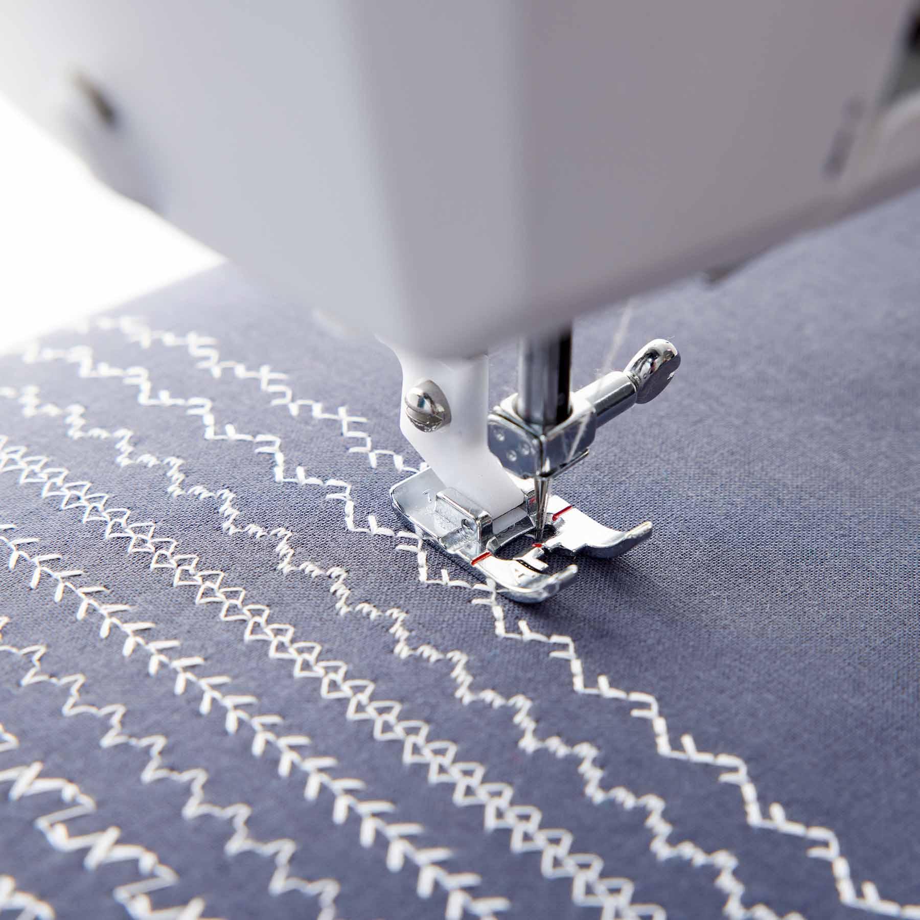HUSQVARNA VIKING ONYX 25 Sewing machine needle stitching a various pattern on fabric.