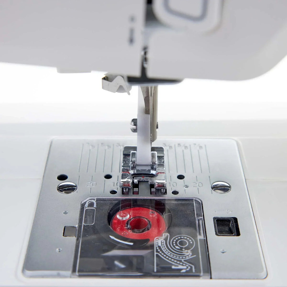 Close-up of a HUSQVARNA VIKING ONYX 25 sewing machine needle and presser foot.