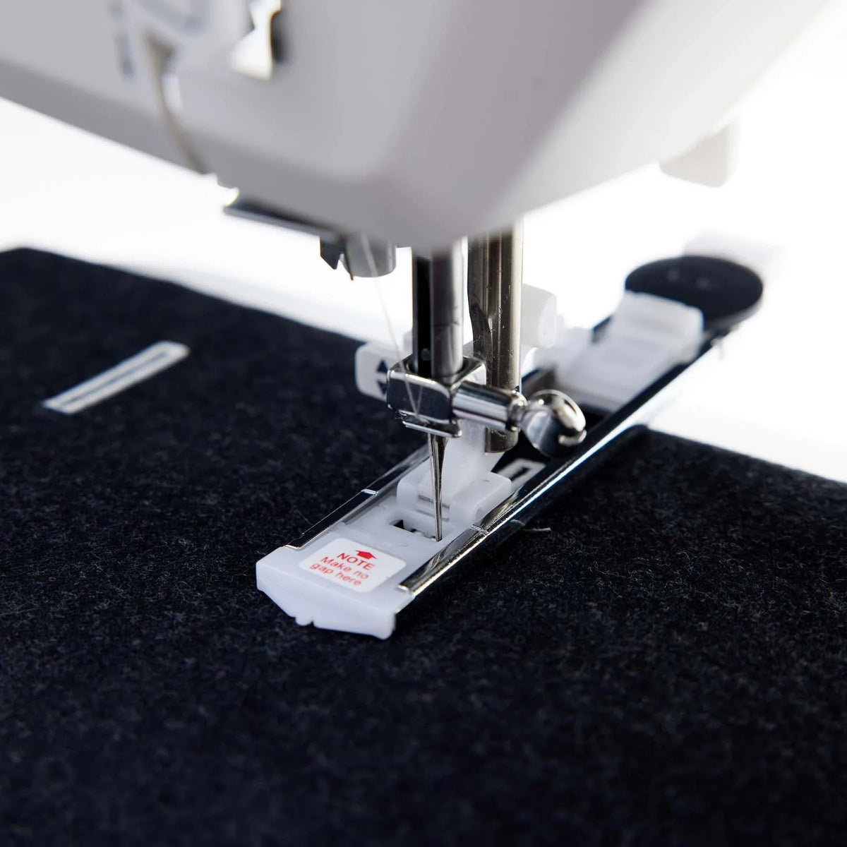 Close-up of a HUSQVARNA VIKING ONYX 25 sewing machine needle.