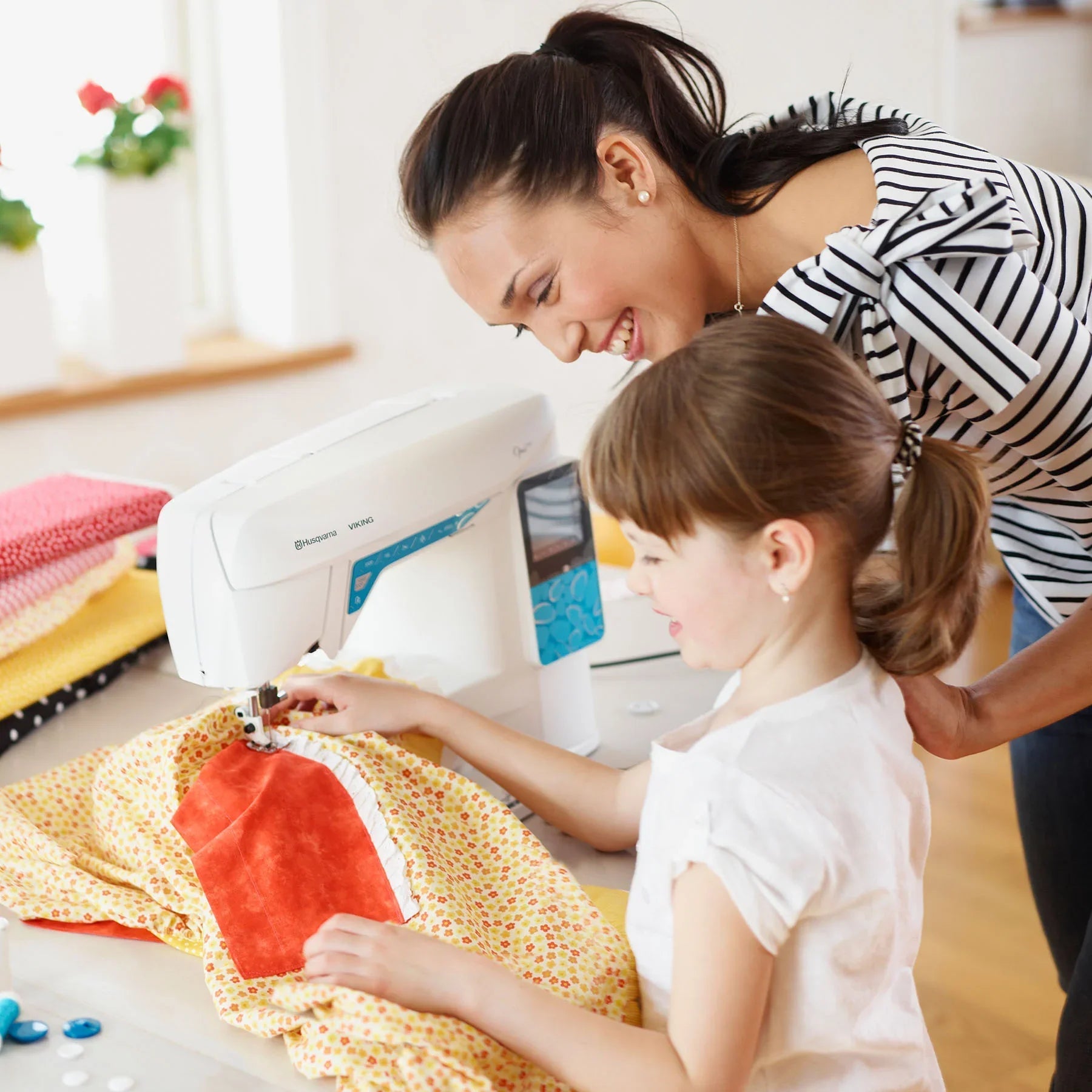 An image of mother and daughter using HUSQVARNA® VIKING® OPAL™ 670 Sewing Machine.