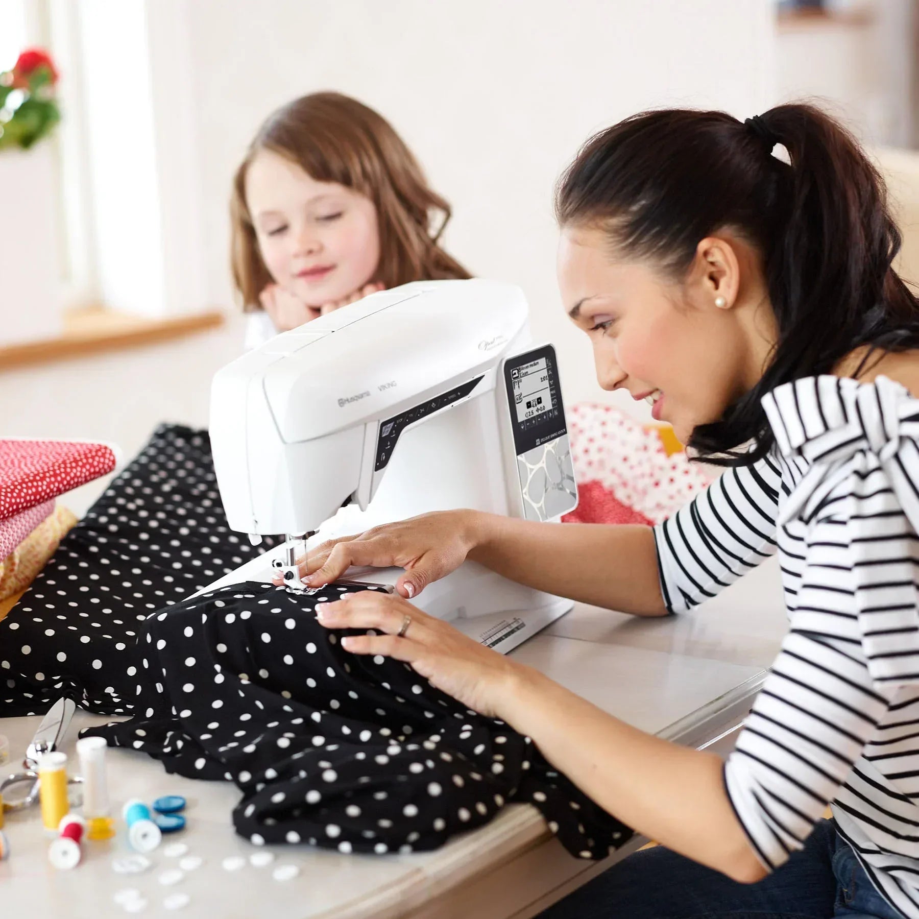 Woman and child using HUSQVARNA VIKING OPAL 690Q Sewing Machine.