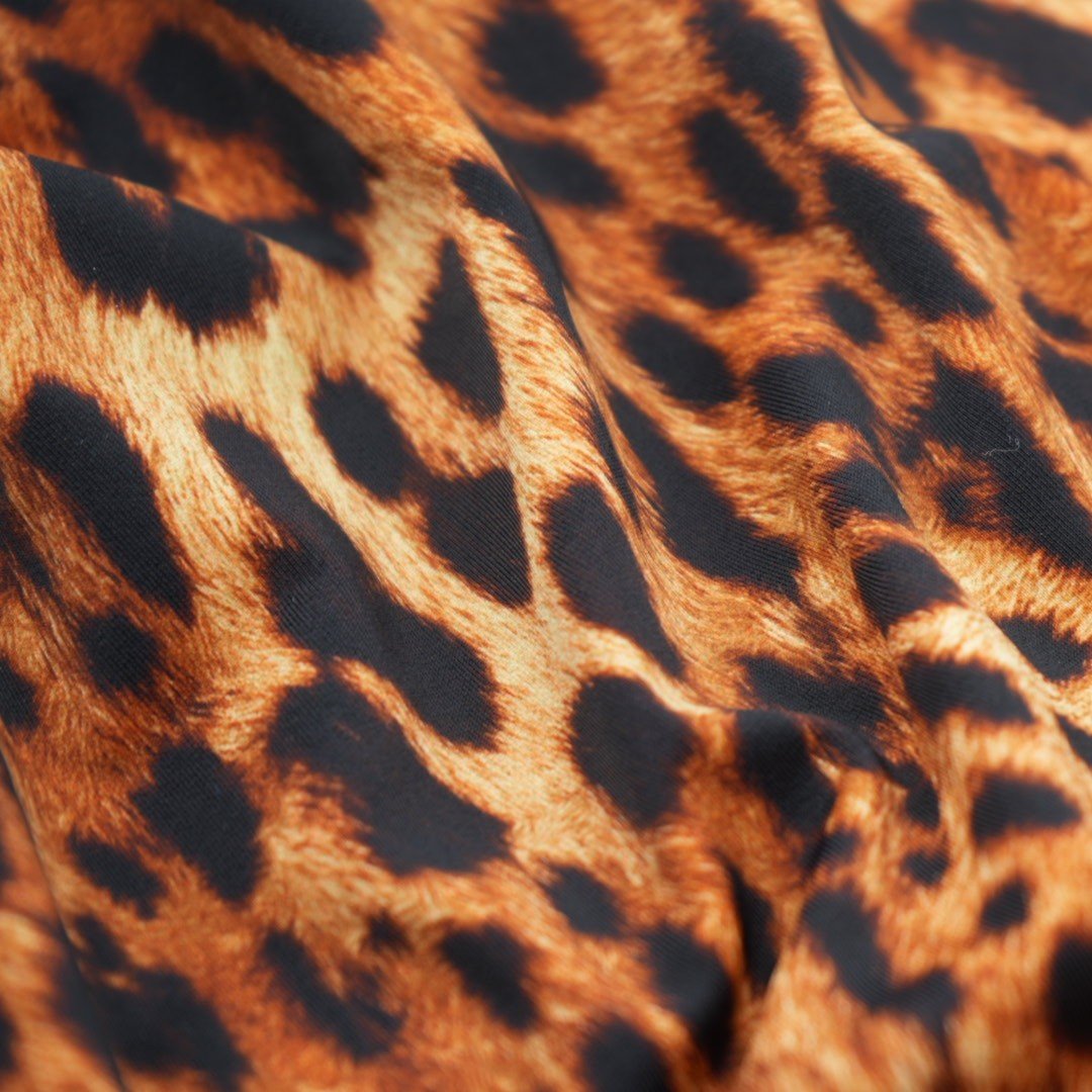 A sample piece of Leopard Spotted Safari Printed Spandex Fabric.