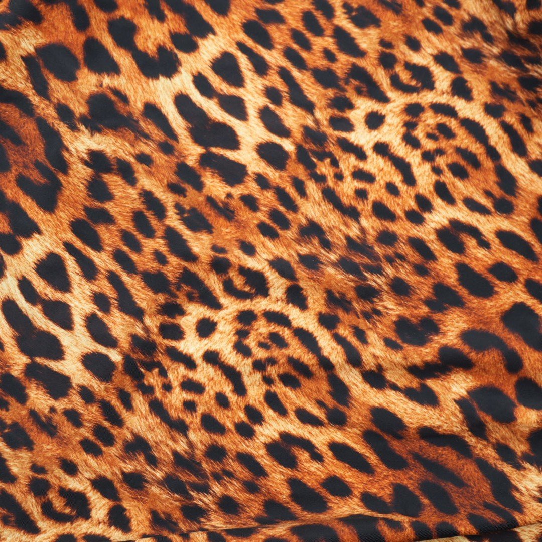 A sample piece of Leopard Spotted Safari Printed Spandex Fabric.