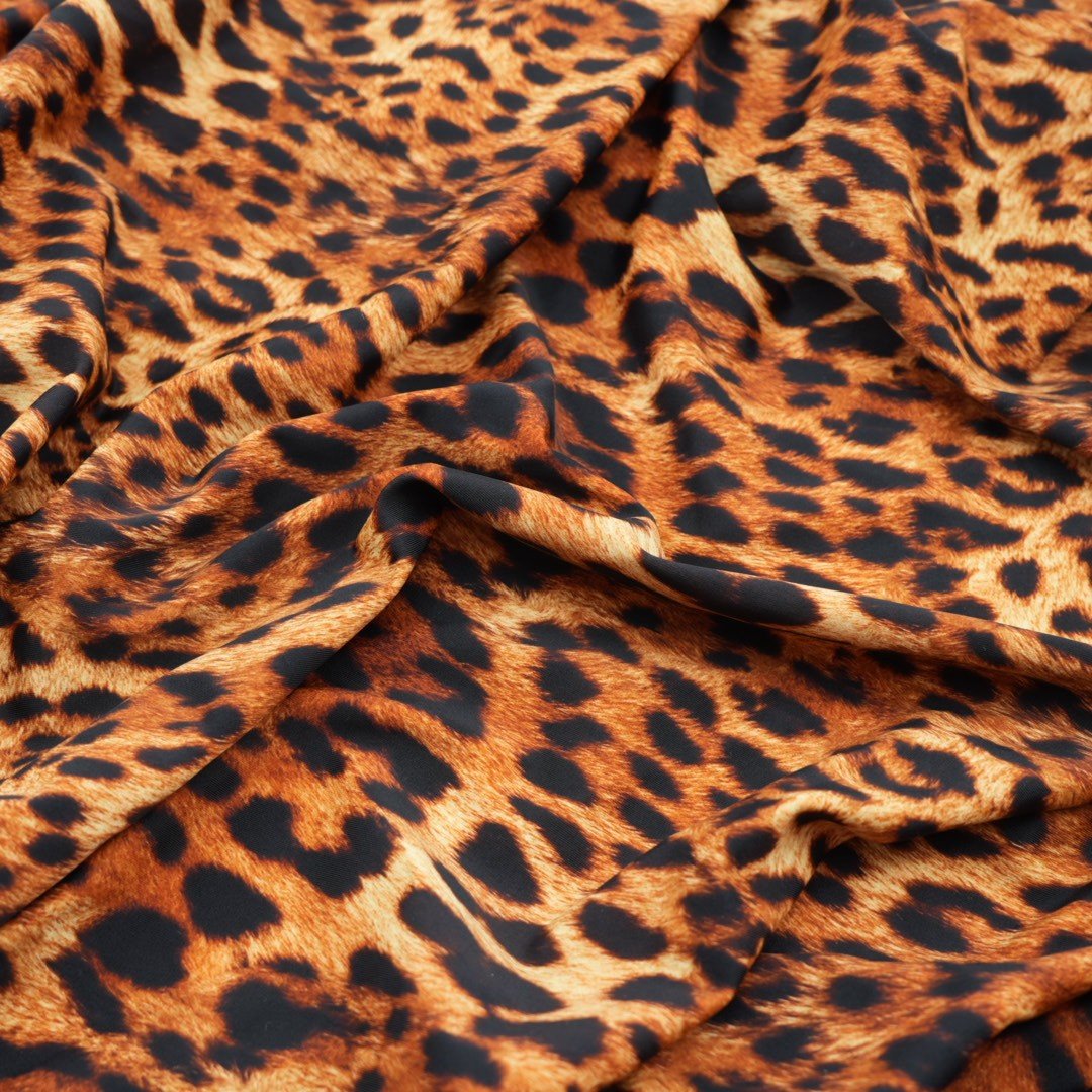 A sample piece of Leopard Spotted Safari Printed Spandex Fabric.