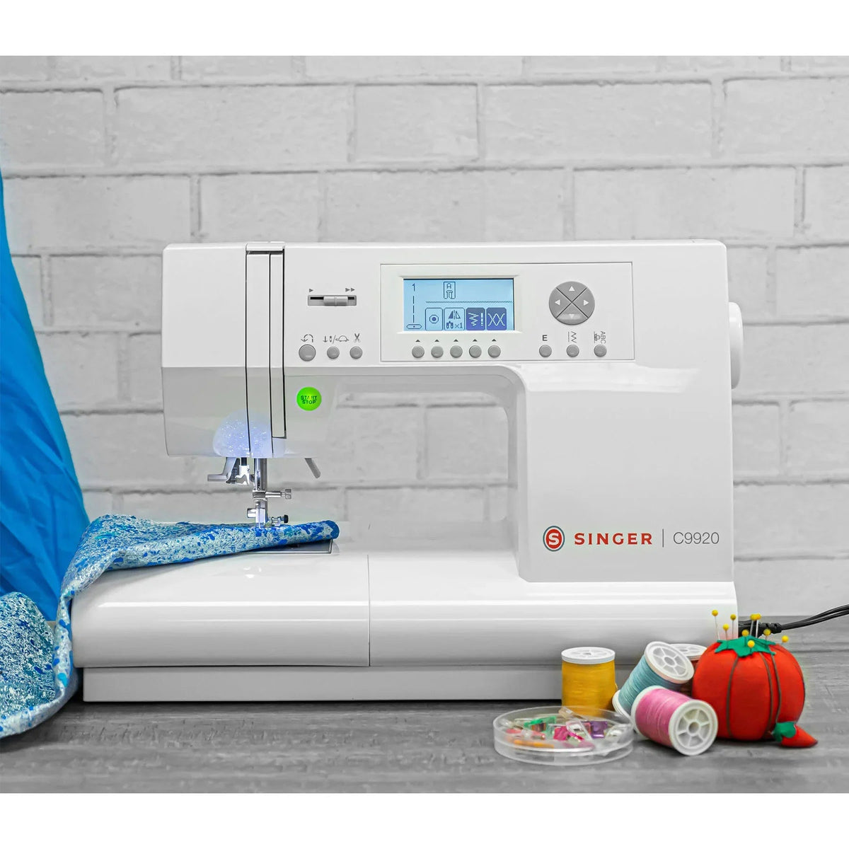 A sample of the Singer C9920 Sewing Machine with threads & fabric.