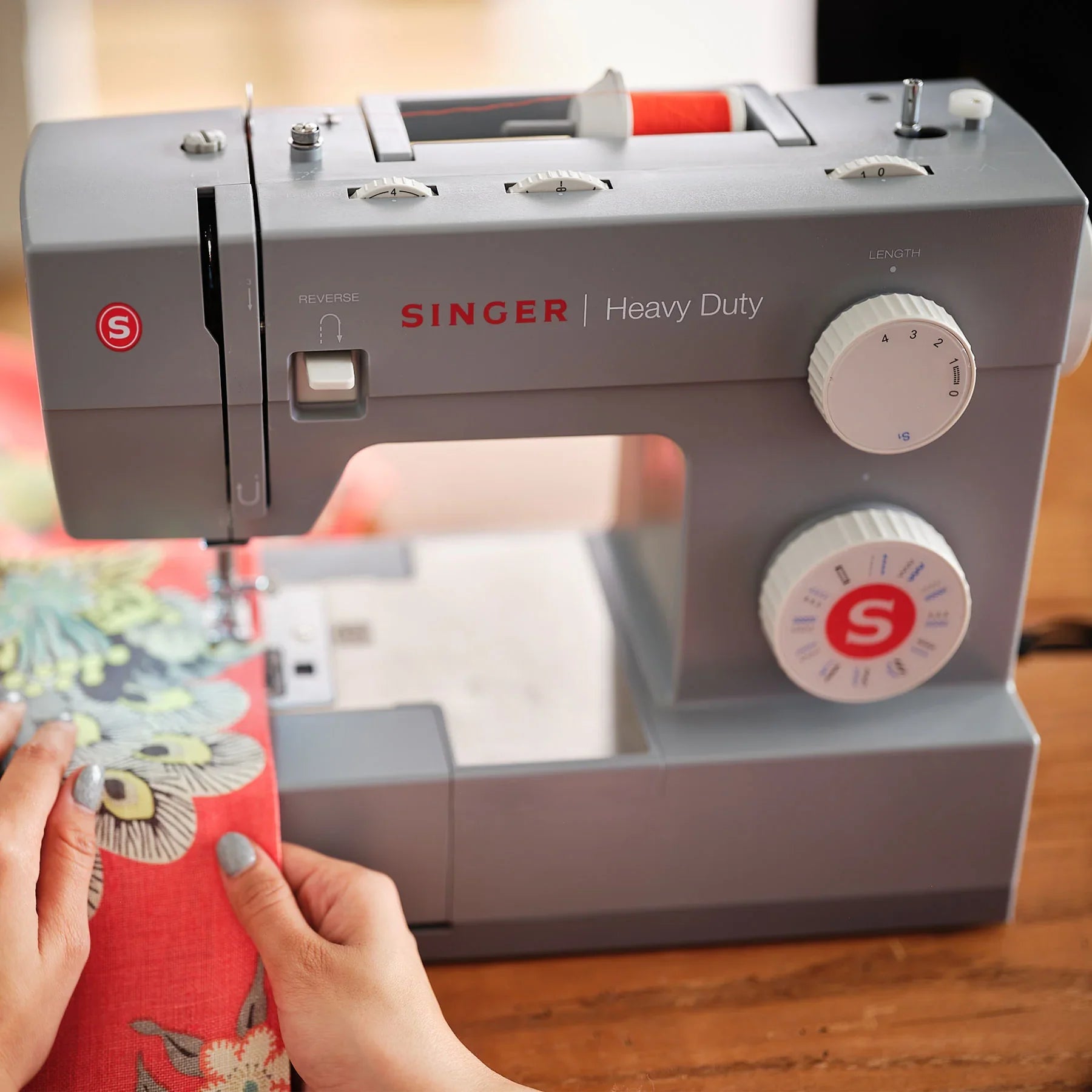 A sample of a person sewing fabric using Singer Heavy Duty 4423 Sewing Machine.