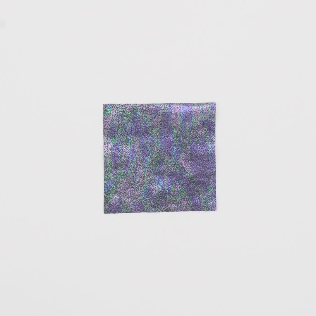 Load video: Close-up video of Iridescent Oil Slick Foiled Spandex fabric showcasing its looks and ability to stretch as a fabric.