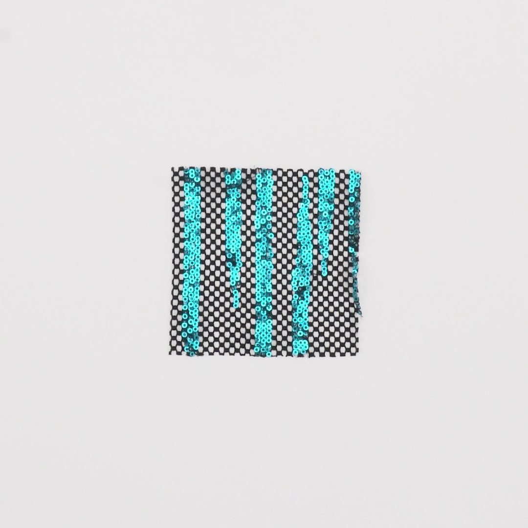 Load video: Close-up video of Flair Stretch Mesh Sequin fabric showcasing its looks and ability to stretch as a fabric.
