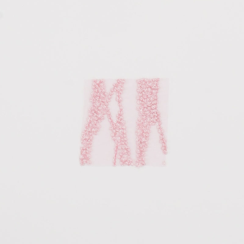 Close-up video of Forget Me Not Embroidered Mesh fabric showcasing its looks and ability to stretch as a fabric.