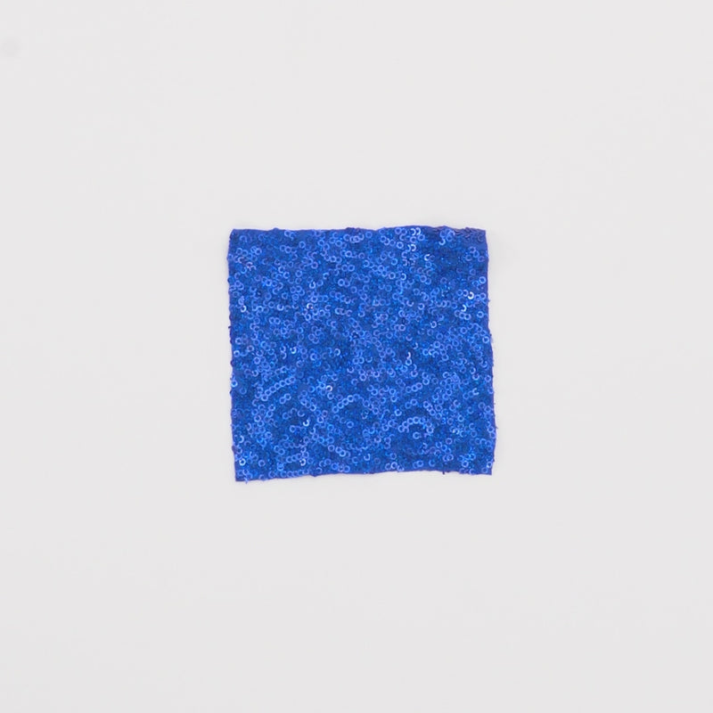 Close-up video of Cosmic GLOW Spandex Sequin Fabric in color royal showcasing its looks and ability to stretch as a fabric.