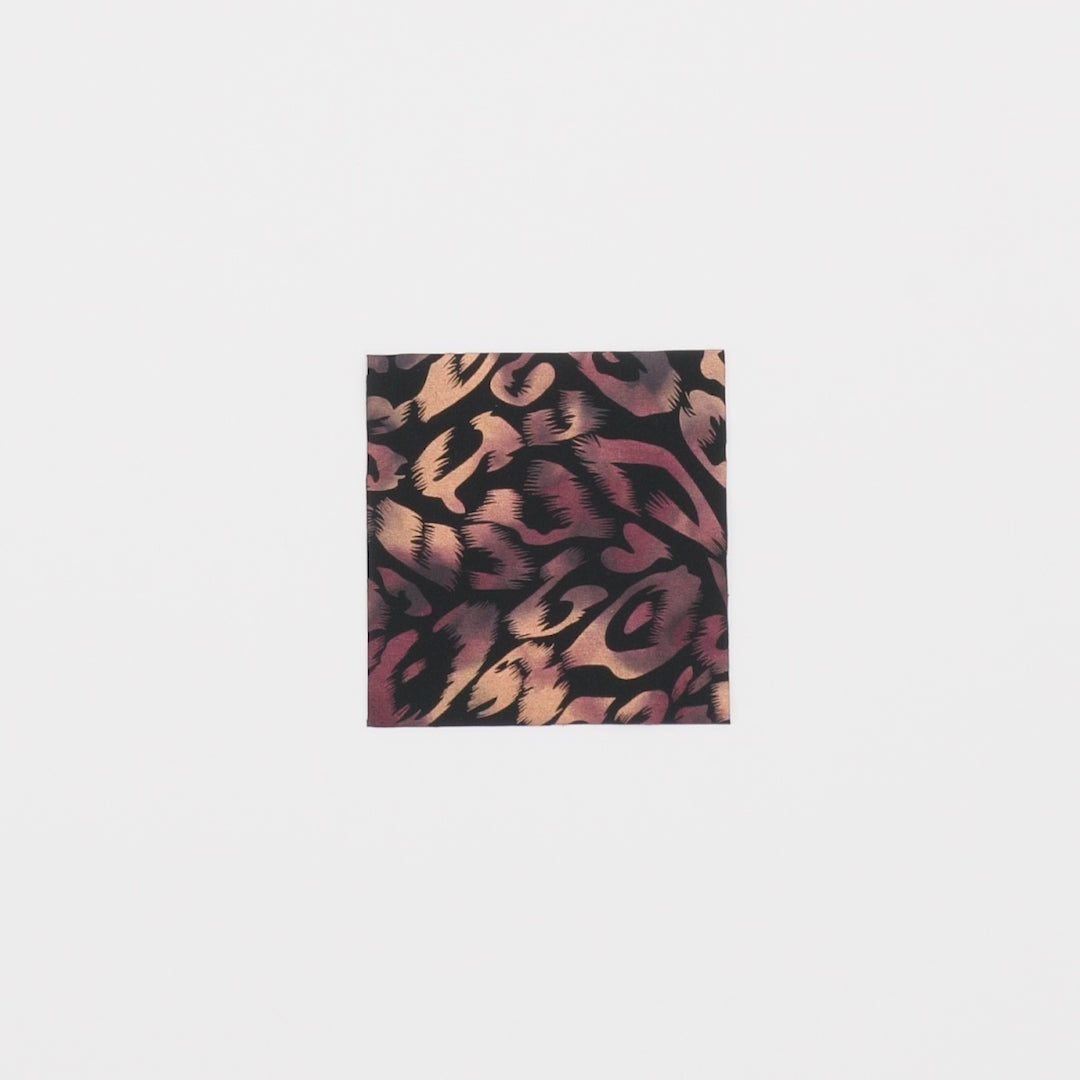 Load video: Close-up video of Fierce Foil Printed Superflex Heavy Compression Spandex in color Black/Burgundy/Tan showcasing its looks and ability to stretch as a fabric.
