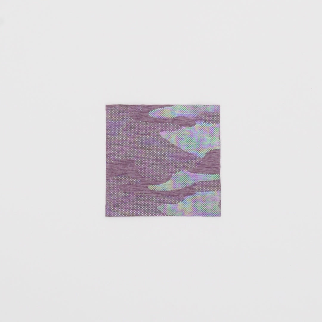 Load video: Close-up video of GI Jane Foil Printed EcoDeslish Fabric in color Dusty Lilac/Iridescent showcasing its looks and ability to stretch as a fabric.