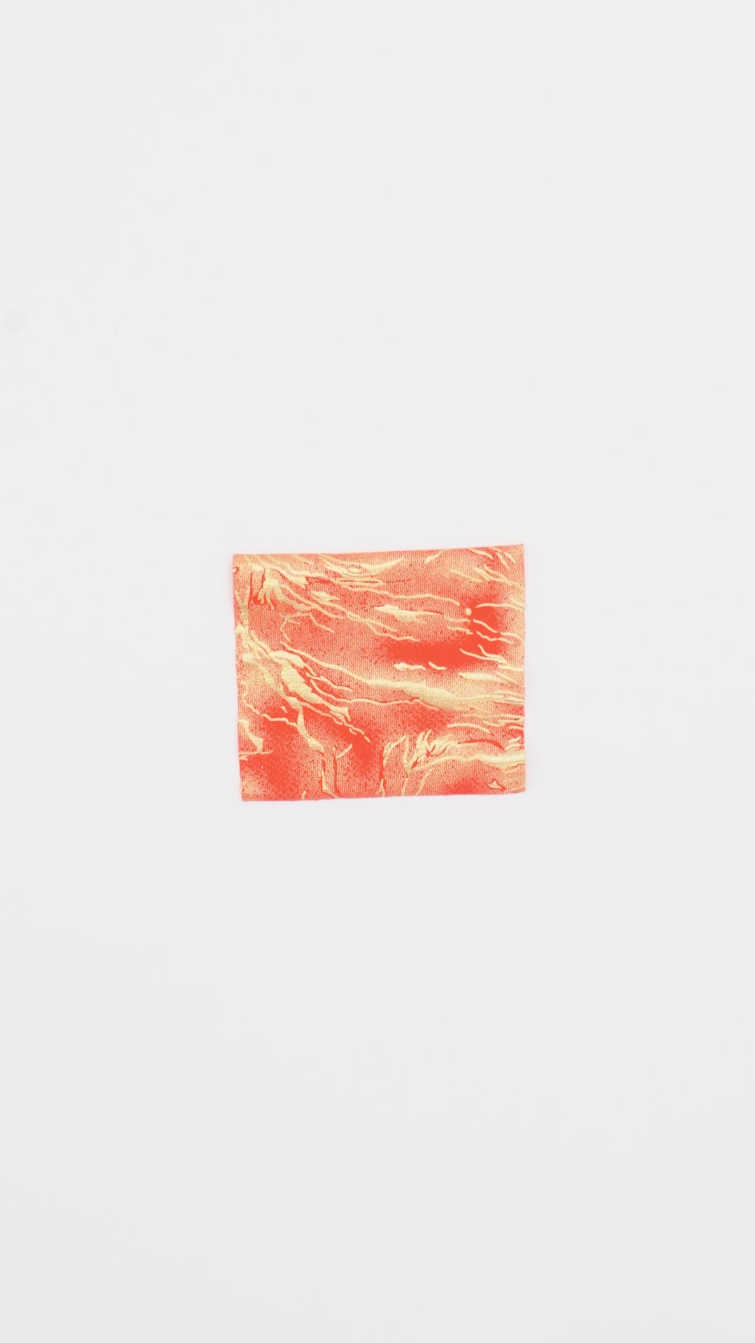 Load video: Close-up video of Thunder Hologram Spandex Fabric in color coral/gold showcasing its looks and ability to stretch as a fabric.