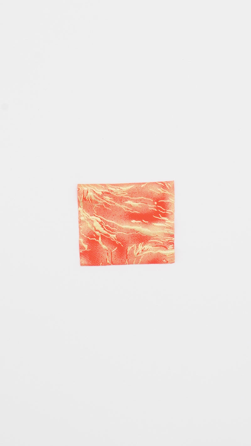 Close-up video of Thunder Hologram Spandex Fabric in color coral/gold showcasing its looks and ability to stretch as a fabric.