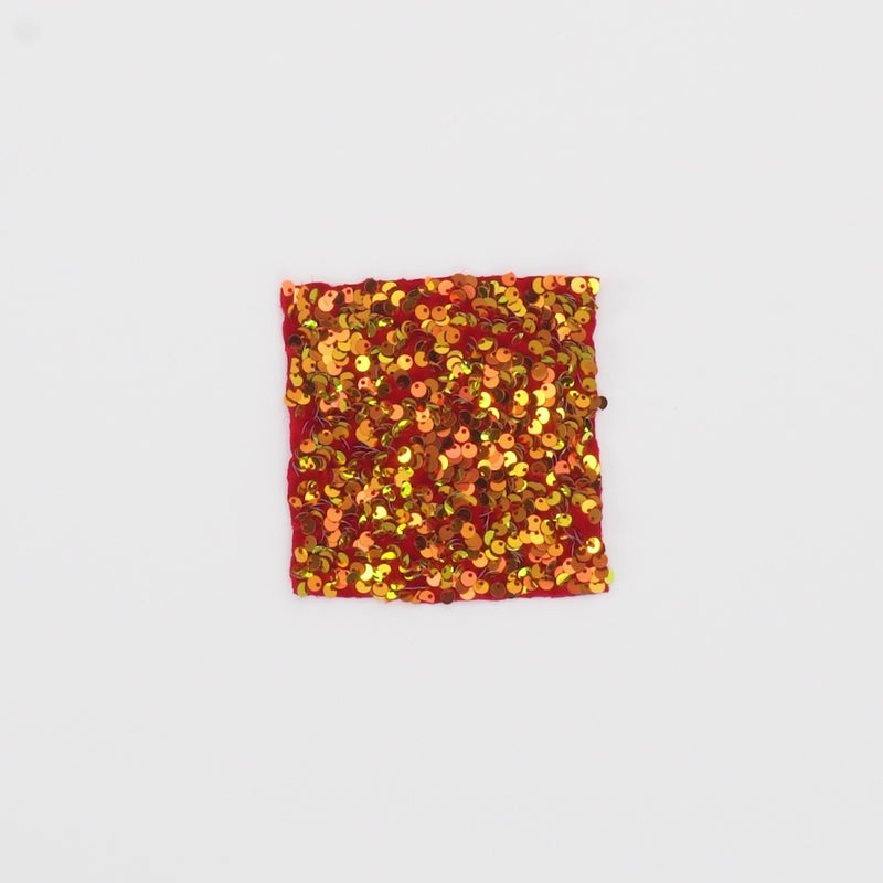 Close-up video of Duchess Stretch Velvet Sequin Fabric in color Red/Iridescent Red showcasing its looks and ability to stretch as a fabric.