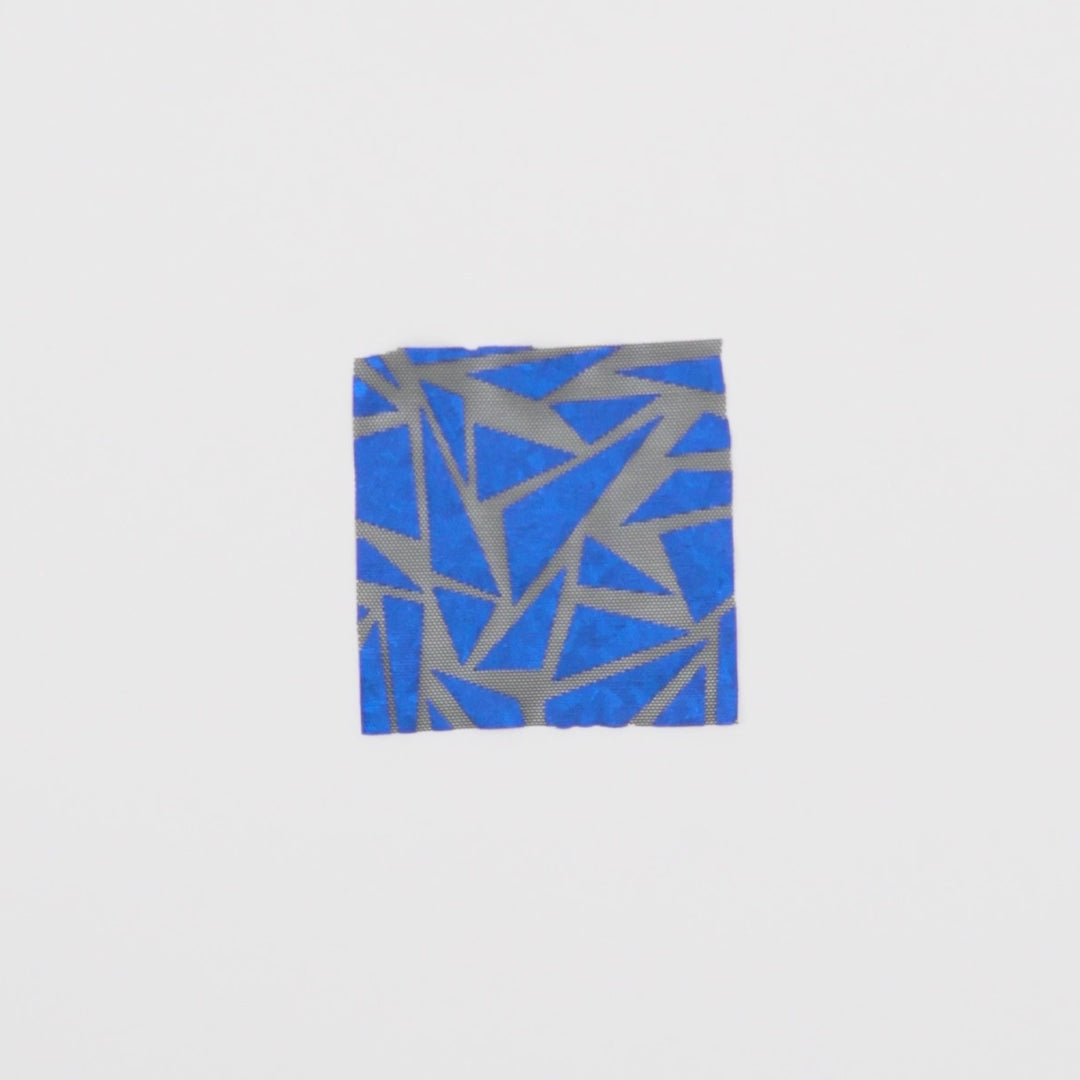 Load video: Close-up video of Abstract Triangle Foil Printed Mesh fabric showcasing its looks and ability to stretch as a fabric.