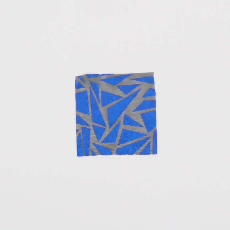Close-up video of Abstract Triangle Foil Printed Mesh fabric showcasing its looks and ability to stretch as a fabric.