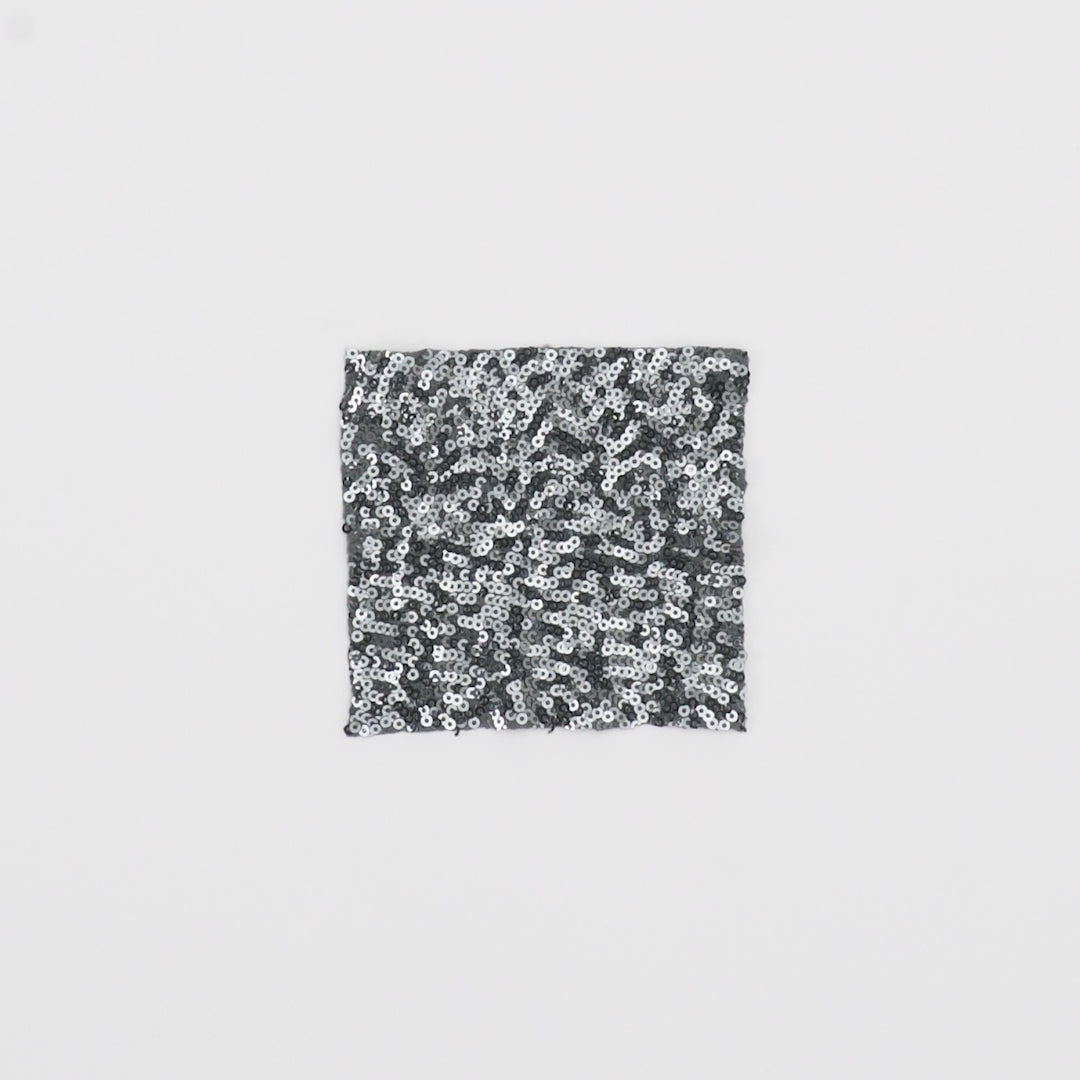 Load video: Close-up video of Cosmic 4-Way Stretch Sequin on Spandex Fabric in color Gunmetal showcasing its looks and ability to stretch as a fabric.