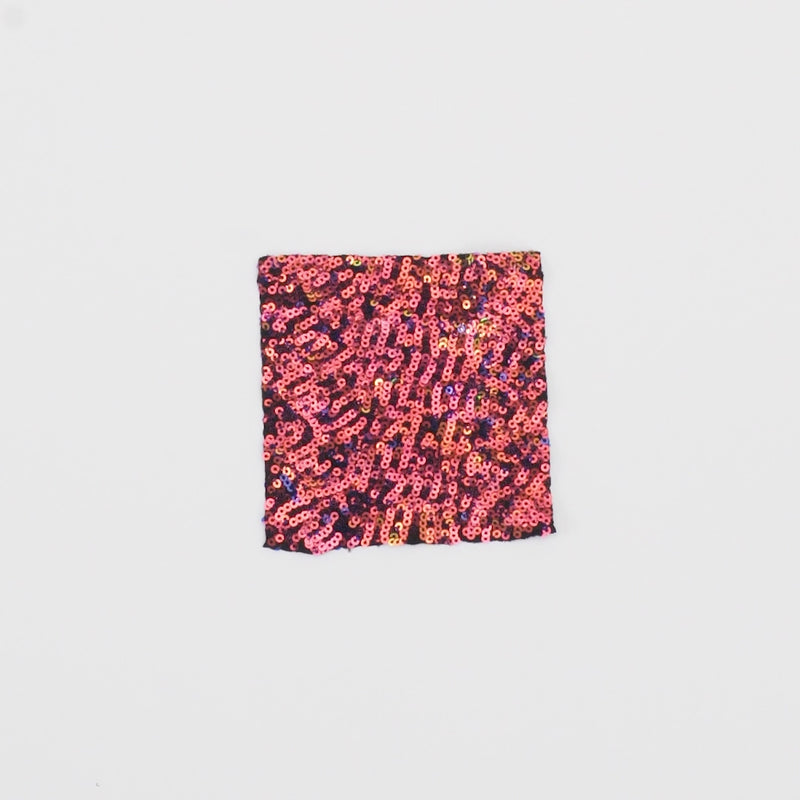 Close-up video of Cosmic X Spandex Sequin Fabric in color Black/Red Iridescent showcasing its looks and ability to stretch as a fabric.