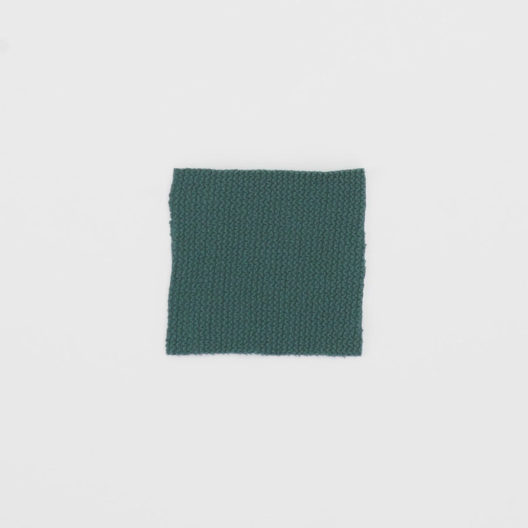 Load video: Close-up video of Popcorn Polyester Spandex Jacquard Fabric showcasing its looks and ability to stretch as a fabric.