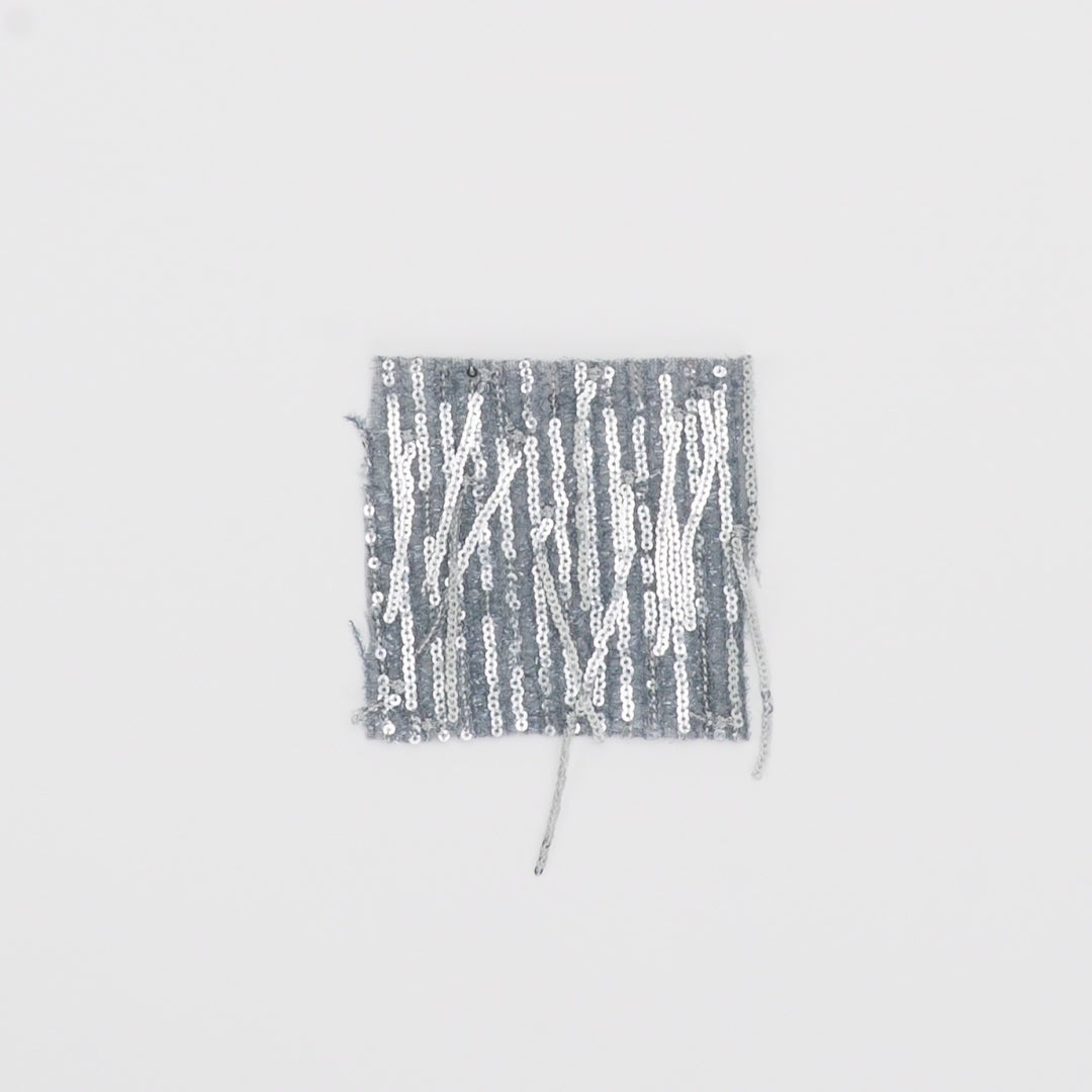 Load video: Close-up video of shimmer polyester Mesh with dangle sequin fabric showcasing its looks and ability to stretch as a fabric.