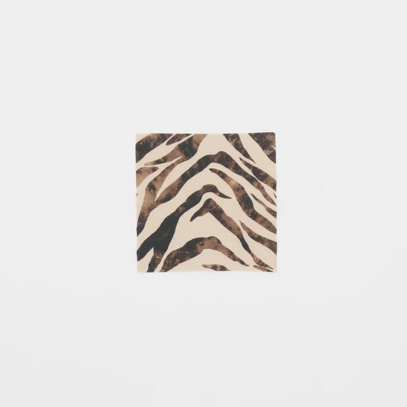 Close-up video of Desert Zebra Foil Printed Spandex Fabric in color Ivory/Shiny Foil showcasing its looks and ability to stretch as a fabric.