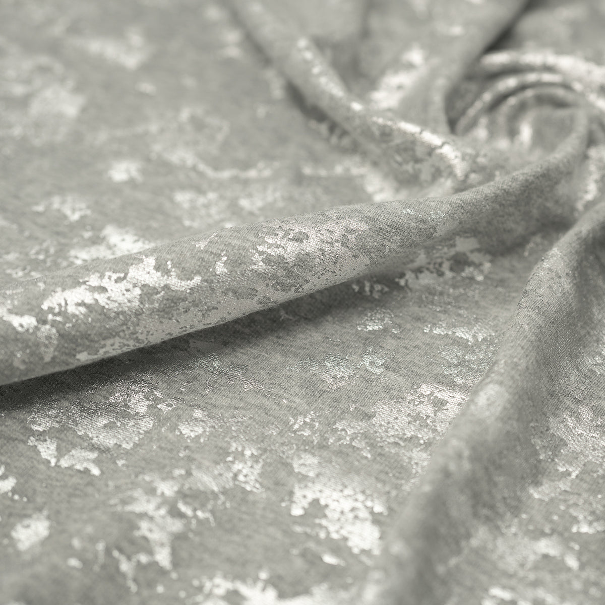 A crumpled piece of Cloud 9 Foil Printed Brushed Terry Fleece in the color Gray/Silver