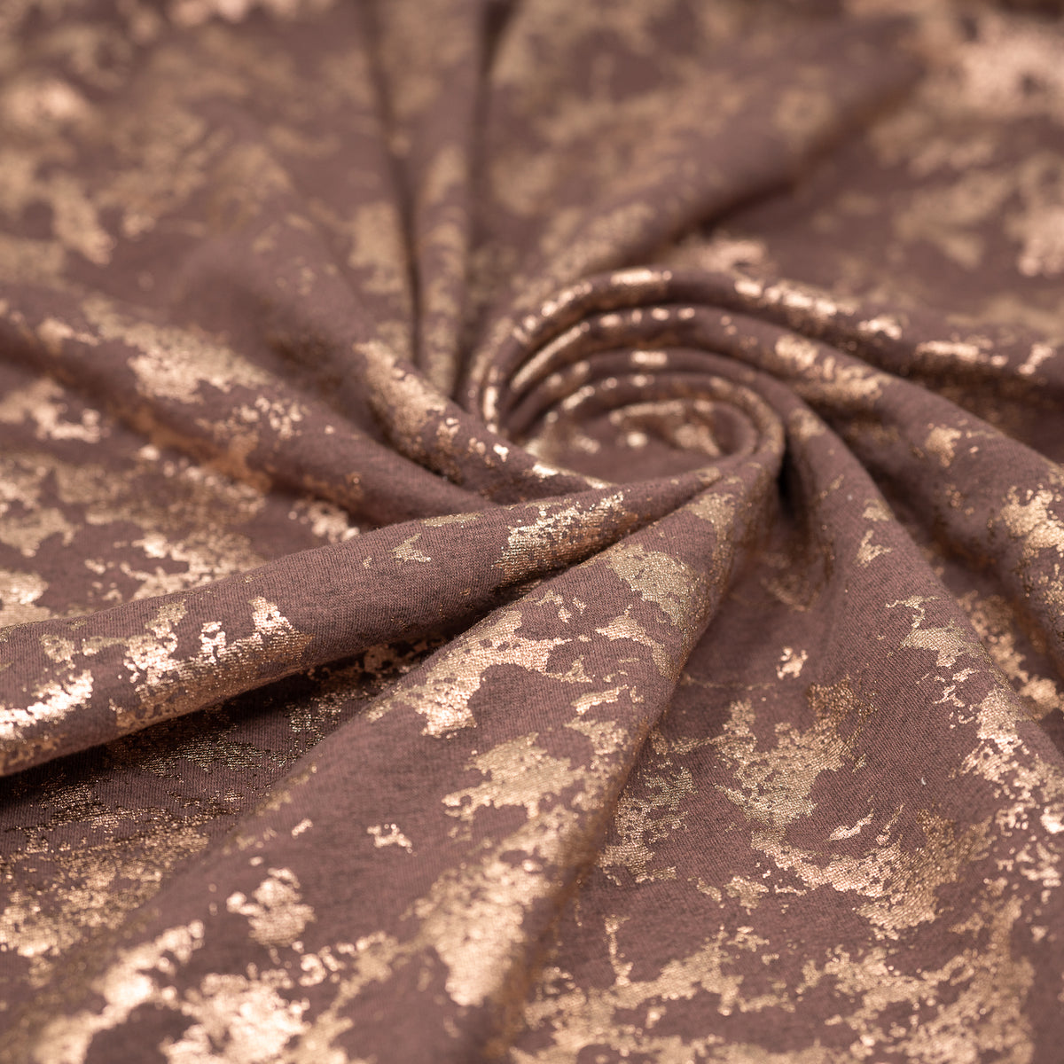 Swirled sample shot of Cloud 9 Foil Printed Brushed Terry Fleece in the color Mauve/Rose Gold