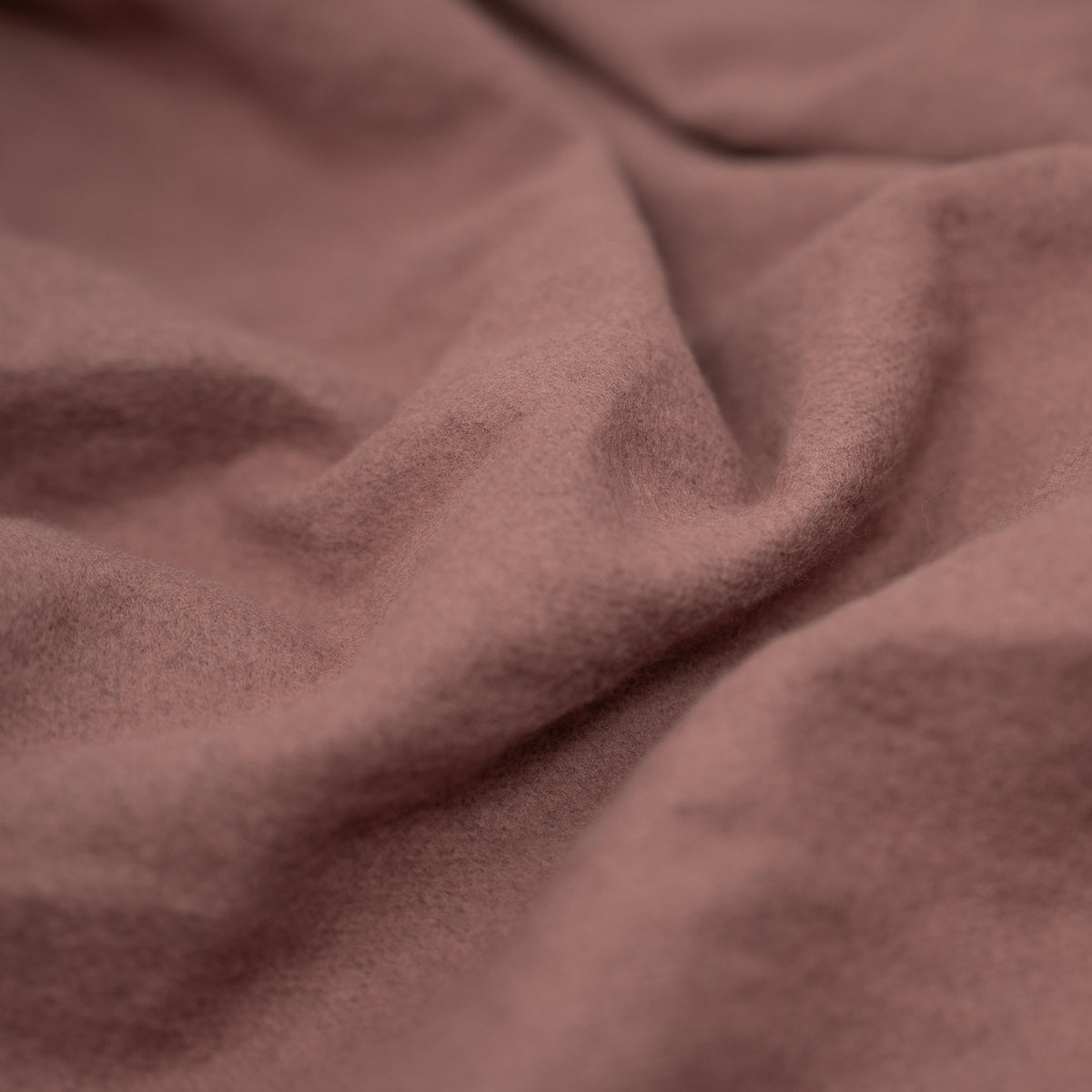 A crumpled piece of Cloud 9 Foil Printed Brushed Terry Fleece in the color Mauve/Rose Gold