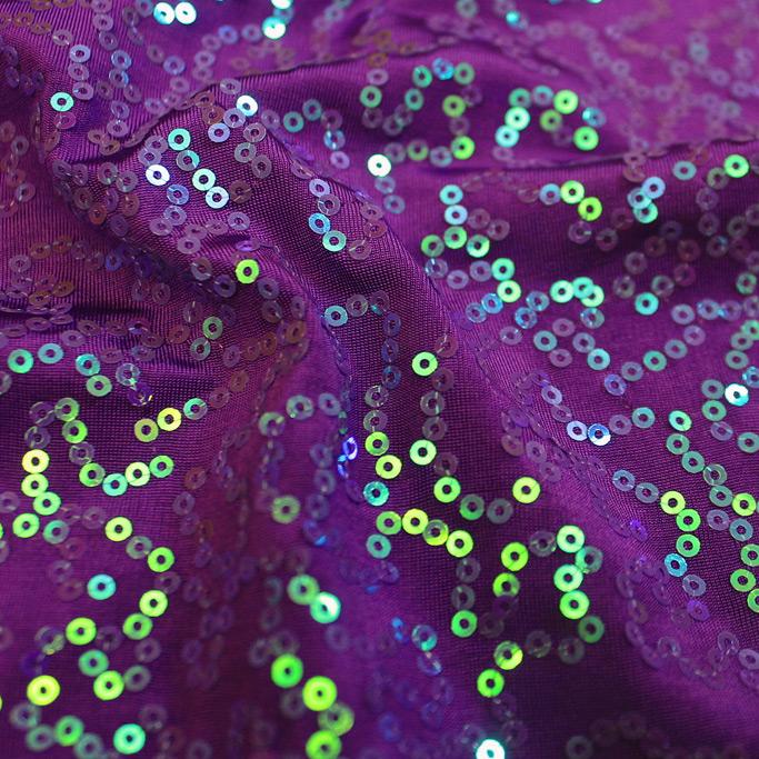 A swirled sample of arriba sequin spandex in the color purple.