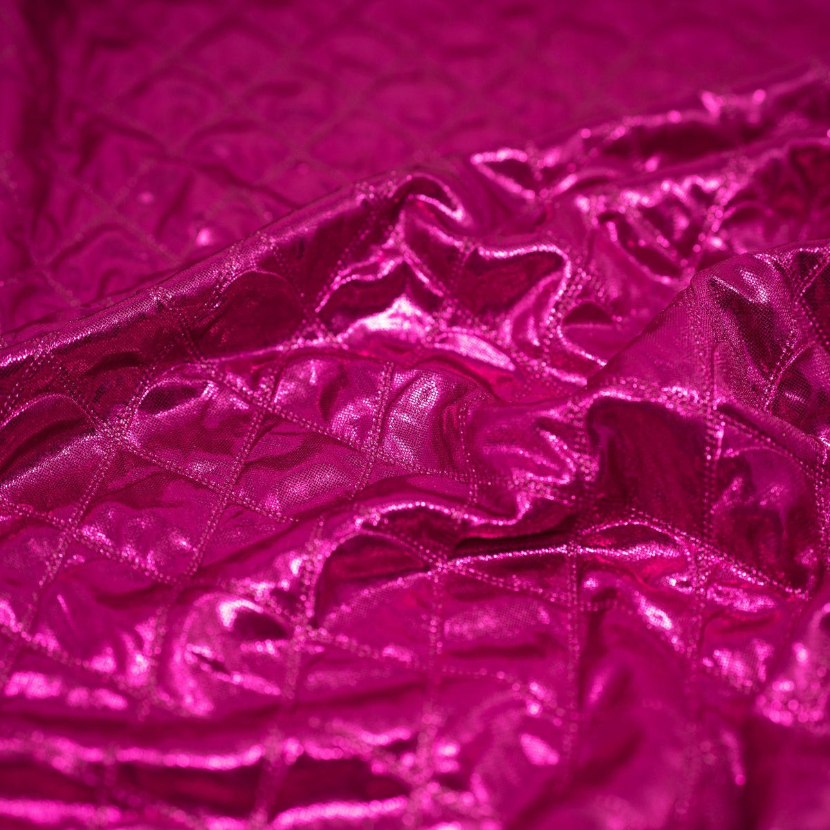 A crumpled piece of Betty Embossed Metallic Polyester in Fuchsia.
